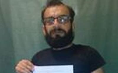 Mehdi Savari holding a letter from detainees to the Australian Human Rights Commissioner.