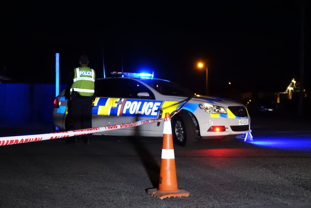 Police at the cordon set up around the house where the bodies were found.