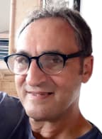 Full frame picture of Wellington photographer Lucien Rizos who wears dark-rimmed glasses