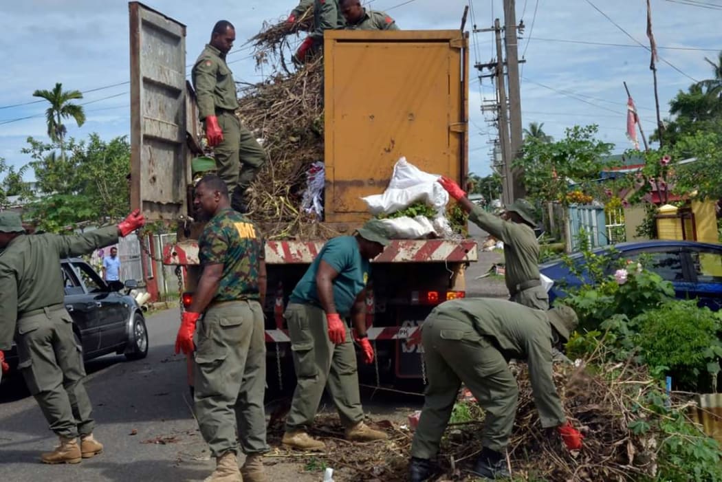 Soldiers help clean up in the capital Suva.