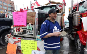Trucker Jay Vanderwier stands in front of his truck as demonstrators continue to protest the vaccine mandates implemented by Prime Minister Justin Trudeau, on February 8, 2022 in Ottawa, Canada.