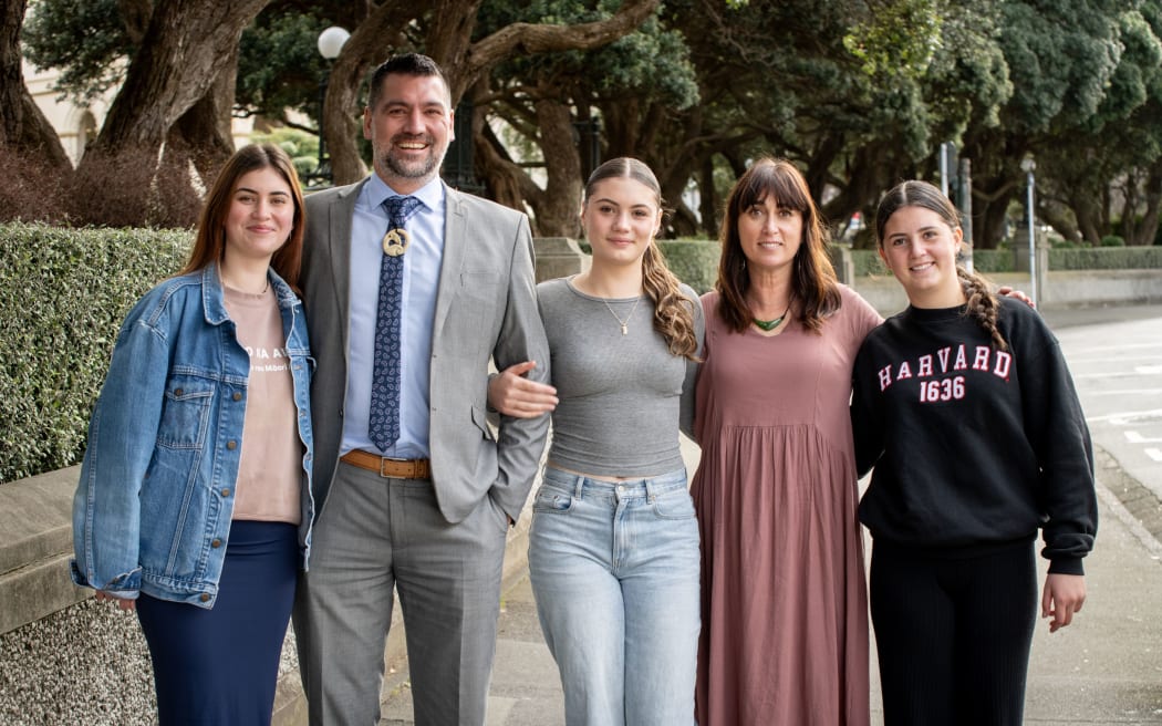 Jeremy Banks and his whānau outside the High Court in Wellington.
