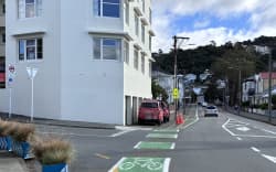 Trade vehicles seen parked on the footpath on Wellington’s Aro St as electricians rewired the main incoming power to restore power to households.