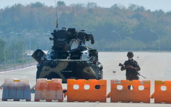 A soldier stands guard on a blockaded road to Myanmar's parliament in Naypyidaw on 1 February 2021, after the military seized power in a coup against the elected government of NLD leader Aung San Suu Kyi.