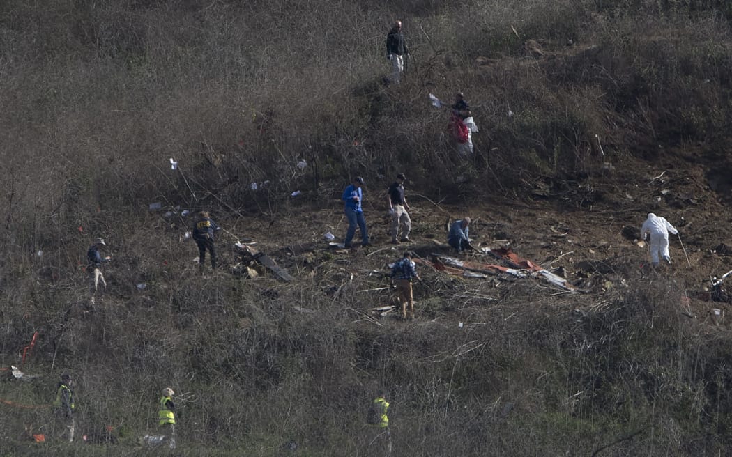 Investigators work at the scene of a helicopter crash in Calabasas, California on Monday, January 27, 2020 that killed 9 people included former Los Angeles Laker star and NBA legend Kobe Bryant and his daughter Gianna Maria.