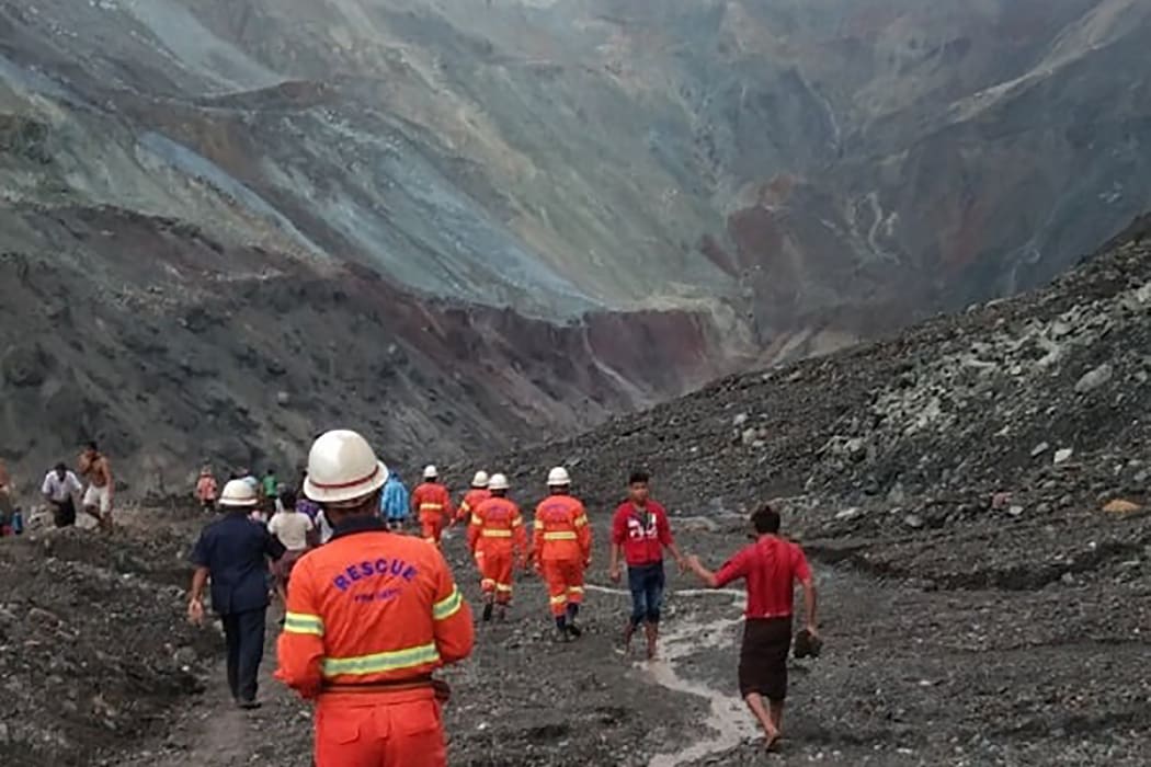 Rescuers attempting to locate survivors after a landslide at a jade mine inthe  Hpakant of Kachin state.