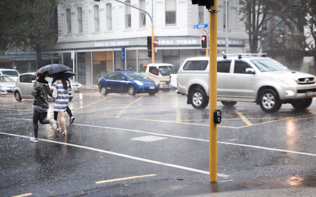 Rain pours down in the Auckland CBD.