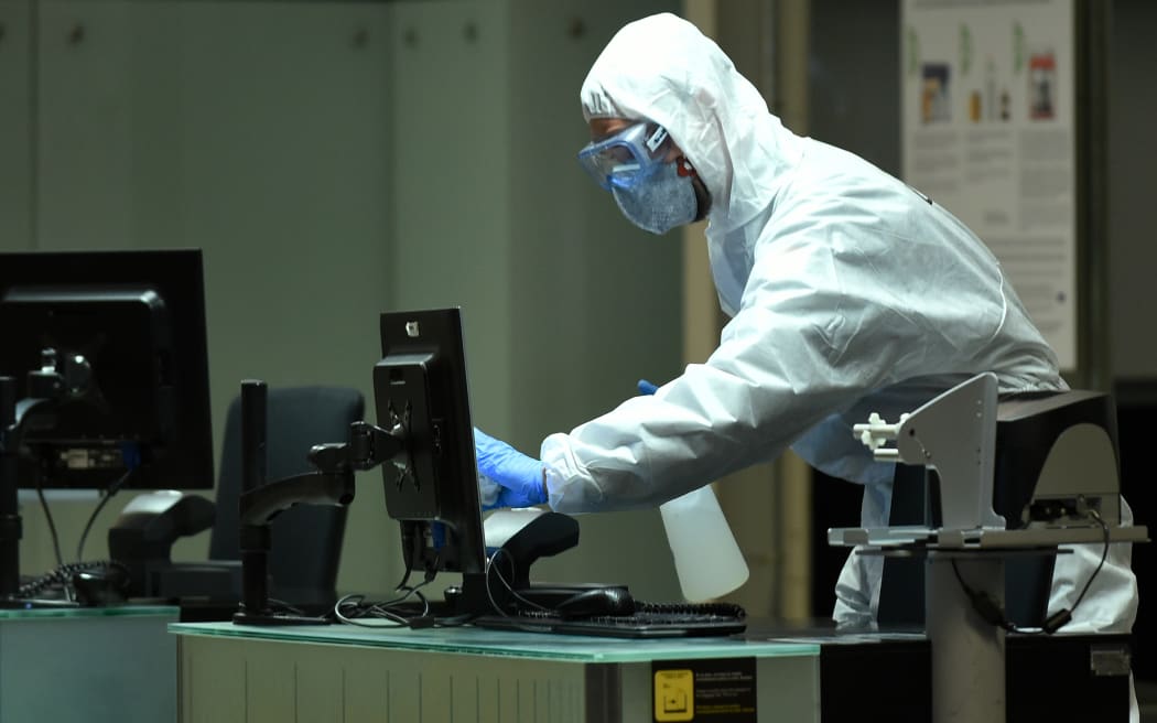 A members of the military emergencies unit (UME) carrying out a disinfection at an airport in Barcelona, 19 March.