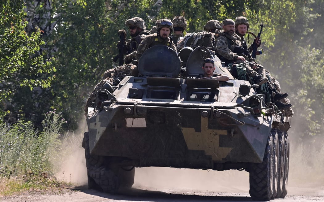 Ukrainian soldiers on top of a Ukrainian armoured fighting vehicle are pictured on a road in the countryside of Siversk, in Donetsk Oblast, eastern Ukraine, on 8 July 2022.