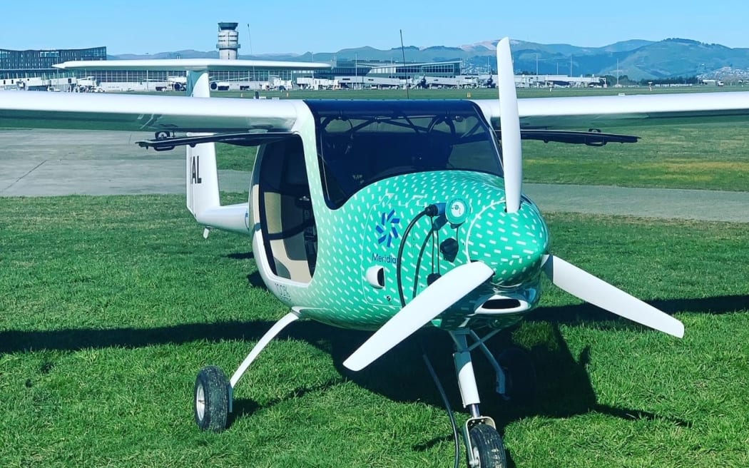 An electric aircraft plugged in for charging.