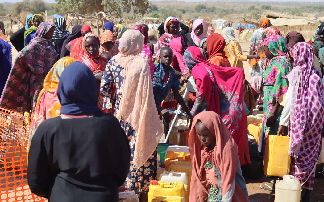 Refugees fleeing the conflict in Sudan queue with their jerrycans to queue to collect drinking water from the Doctors Without Borders (MSF) distribution point at the Ourang refugee camp in Adre on December 7, 2023. The conflict raging in Sudan has thrown hundreds of thousands of people into exile, to flee the violence in Darfur, where the international community is worried about ethnic cleansing, many finding refuge in camps of eastern Chad.