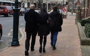Suzanne Derrett, centre, leaves court with supporters.