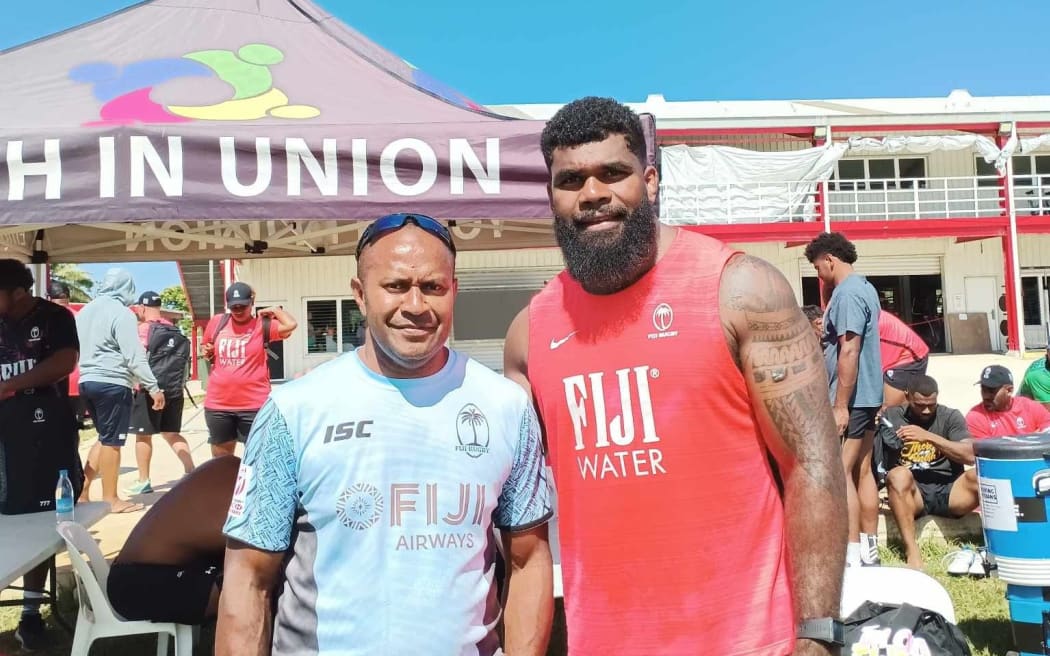 Fijian fan Jonetani Baisagale, who lives in Nuku'alofa, with Flying Fijian number eight Albert Tuisue in Kolomotu'a, Tonga on Thursday after the team's captain run. Photo: Jonetani Baisagale