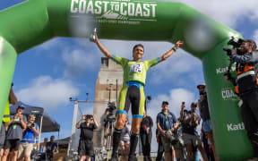 Alex Hunt from Tasmania celebrates after the winning the Coast to Coast Longest Day men's race at New Brighton, Christchurch. 8 Feb, 2025.