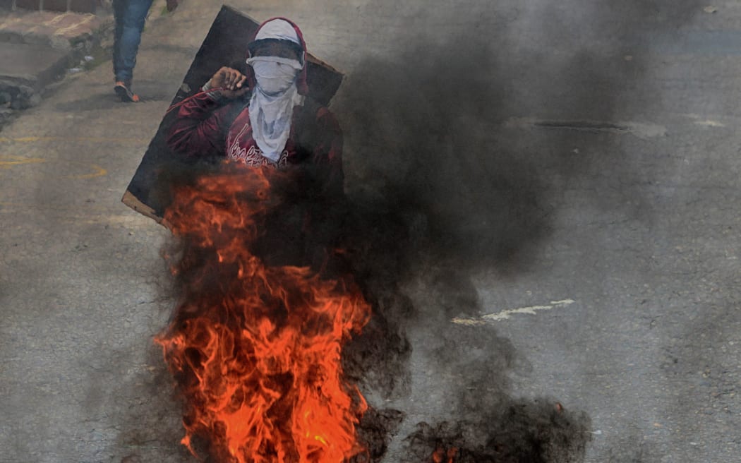 Venezuelan opposition activists clash with the police during a demonstration in San Cristobal, on May 11, 2016.