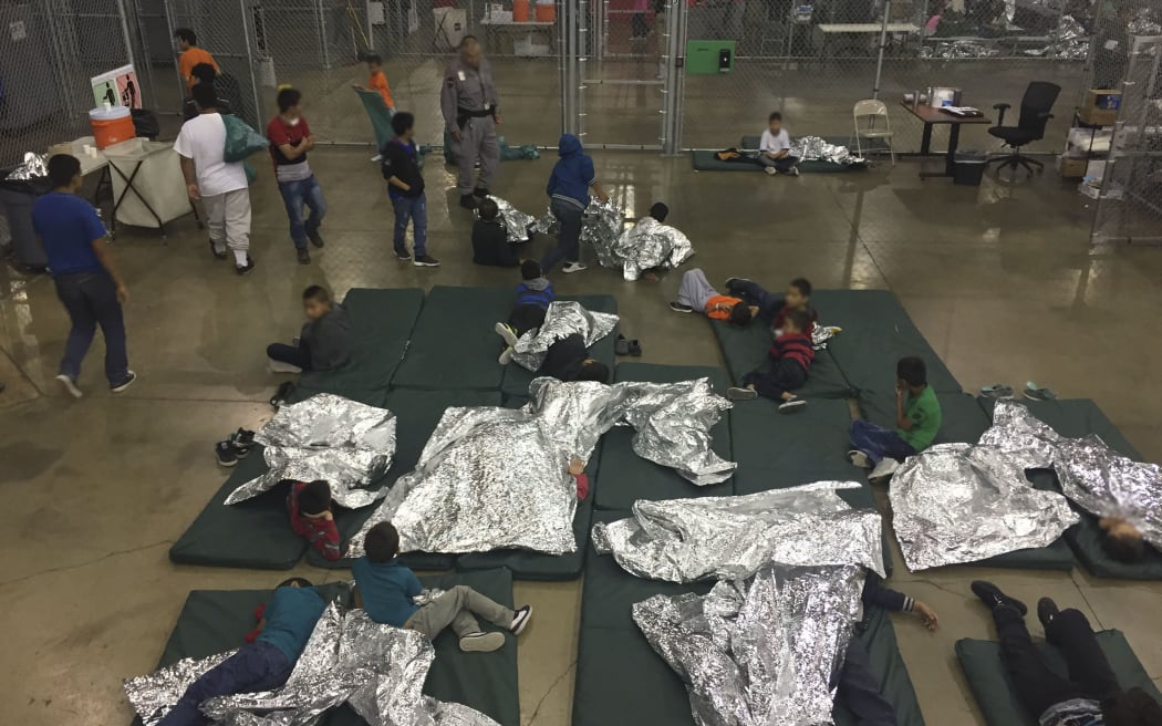 This US Customs and Border Protection photo obtained June 18, 2018 shows intake of illegal border crossers by US Border Patrol agents at the Central Processing Center in McAllen, Texas on 23 May, 2018.
