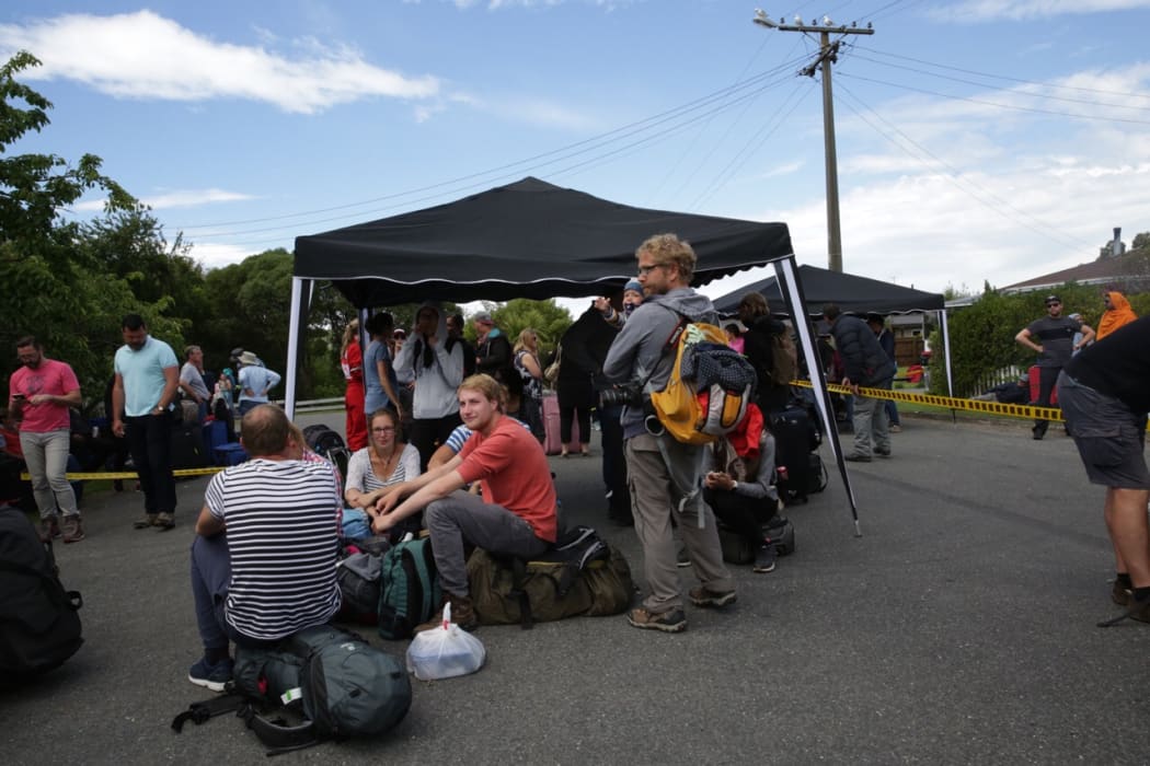 People waiting for buses to HMNZS