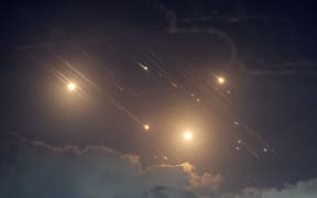 This picture shows projectiles being intercepted by Israel near the northern city of Baqa al-Gharbiya on October 1, 2024. Air raid sirens sounded in central Israel on October 1, the military said, a day after the army launched ground operations into southern Lebanon targeting Hezbollah positions. "Sirens sounded in central Israel," the military said, without providing details of the areas that were affected. (Photo by Ahmad GHARABLI / AFP)