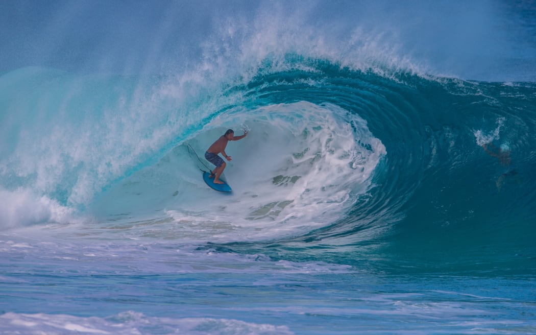 Hawaiian surfer Tamayo Perry goes into the tube at "Insanities" in Haleiwa on the North shore of Oahu as the first "big day" of Winter delivered the first big waves of the season in Hawaii on November 29, 2017. (Photo by Brian Bielmann / http://www.brianbielmann.com / AFP) / RESTRICTED TO EDITORIAL USE