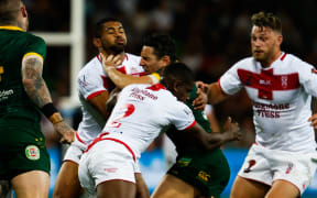 Australia's Billy Slater is tackled by England's Kallum Watkins and Jermaine McGillvary.