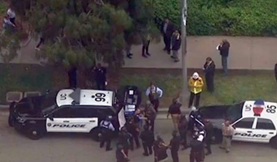 A screengrab from a local television station's live feed shows police at the cordon around the shooting area.