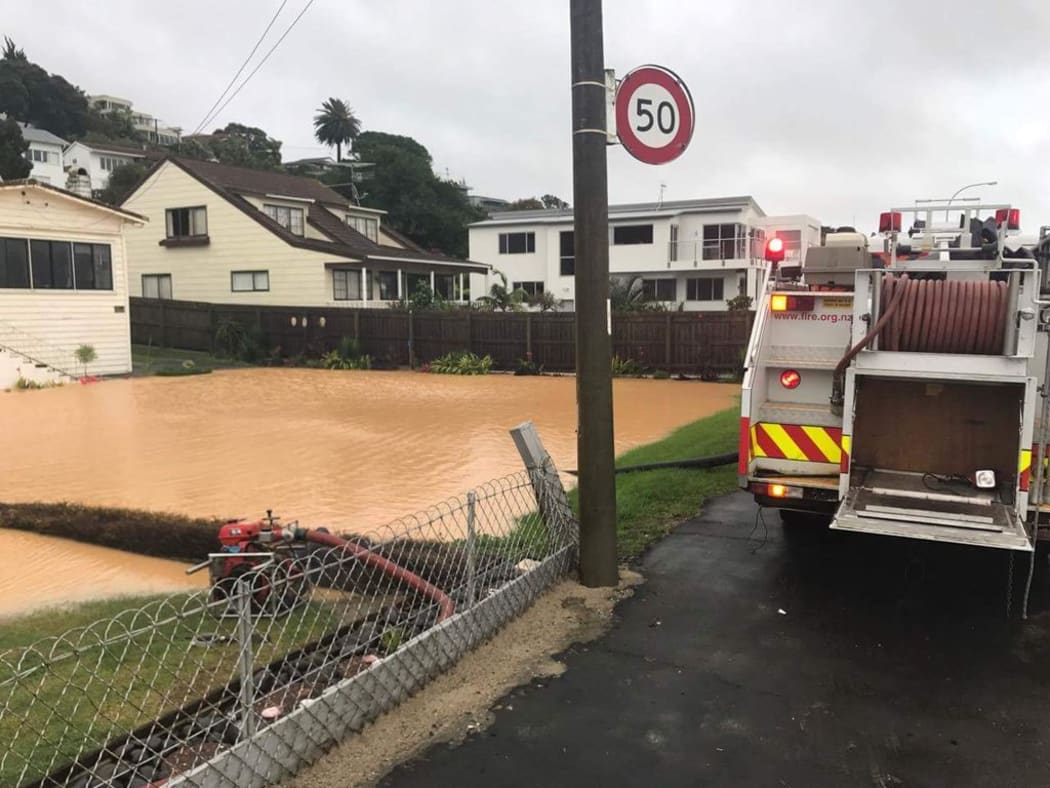 Fire crews at flooded properties on Maraetai Drive, Beachlands, Auckland.