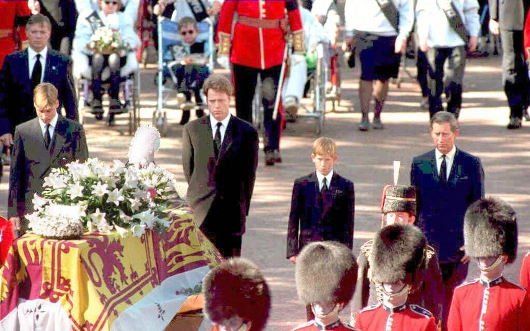 The sons of Diana, Princess of Wales, her brother and her former husband, the Prince of Wales, somberly walk behind her coffin as the funeral procession approaches Westminster Abbey 06 September.  From left to right: Prince William, Earl Spencer, Prince Harry and Prince Charles. (Photo by ADAM BUTLER / POOL / AFP)