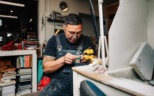Carver Joel Marsters working on a piece of pounamu.