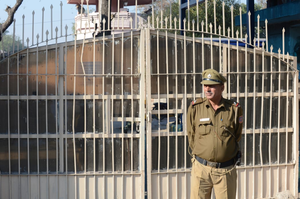 An Indian policeman keeps watch outside Tihar Jail, where four men who were convicted for rape and murder were executed.
