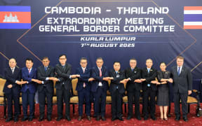 Thai delegates led by Deputy Defence Minister Natthaphon Narkphanit (5th-R), Malaysian Home Minister Saifuddin Nasution Ismail (C) and Cambodian delegates led by Defence Minister General Tea Seiha (5th-L), pose for a group photo ahead of the Extraordinary General Border Committee (GBC) to discuss their border dispute between Thailand and Cambodia, in Kuala Lumpur.