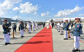 Pope Francis (C) walking past an honour guard as he arrives in Myanmar.