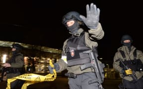 Police with assault rifles stand in front of the closed HDI Arena in Hanover.