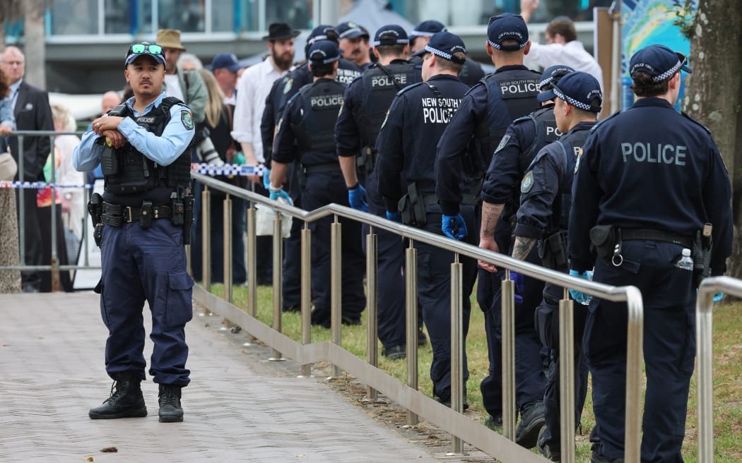 The police search for evidence around the area where the Bondi Beach shooting took place in Sydney on December 15, 2025. Australia's leaders have agreed to toughen gun laws after attackers killed 15 people at a Jewish festival on Bondi Beach, the worst mass shooting in decades decried as antisemitic "terrorism" by authorities. (Photo by DAVID GRAY / AFP)