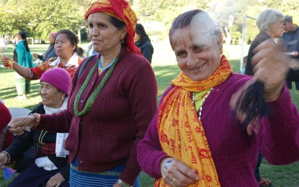 Members of the Nepalese community swing poi to help the record attempt