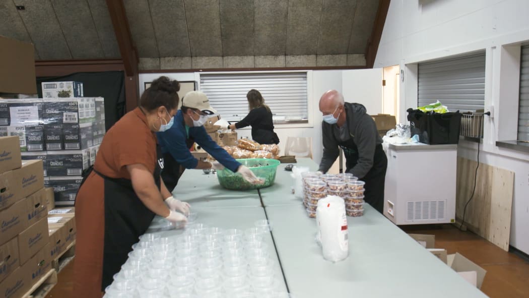 Volunteers prepare meals at Papakura Marae for those in need as unemployment rises.