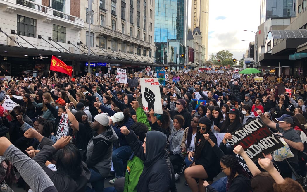 Black Lives matter protesters take a knee outside the US consulate in central Auckland.