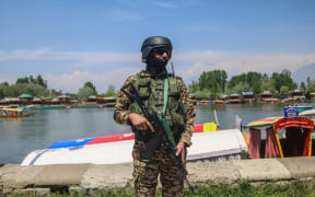 An Indian security personnel patrolling at Dal Lake, a popular tourist destination in India-controlled Kashmir, on 24 April, 2025, following an attack on tourists on 22 April.