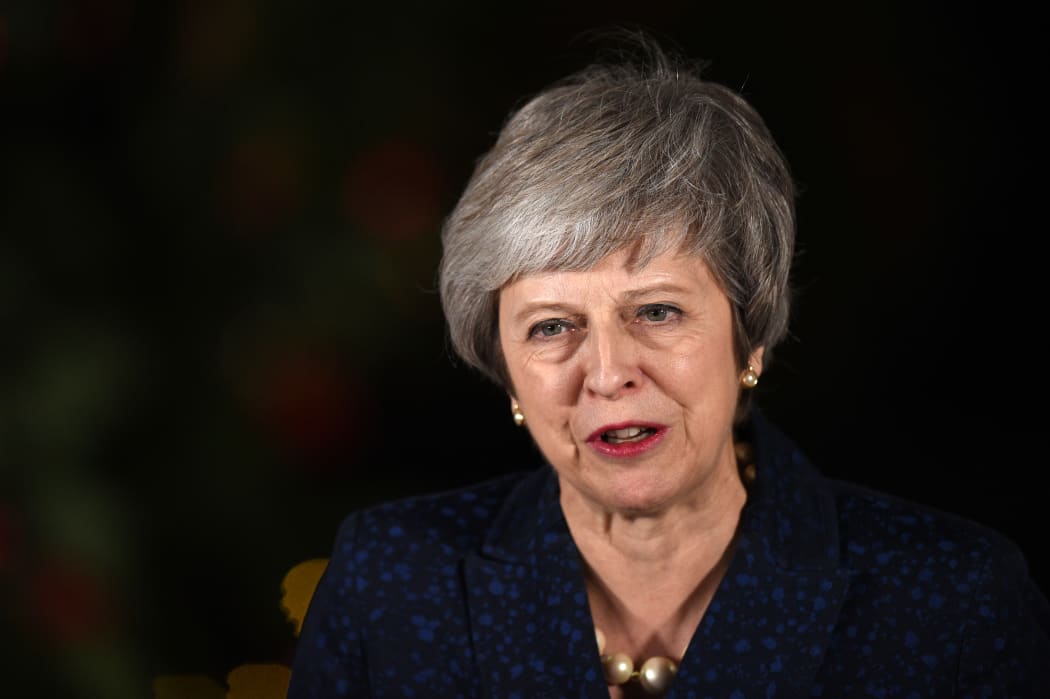 Britain's Prime Minister Theresa May makes a statement outside 10 Downing Street in central London after winning a confidence vote on December 12, 2018. (Photo by Oli SCARFF / AFP)