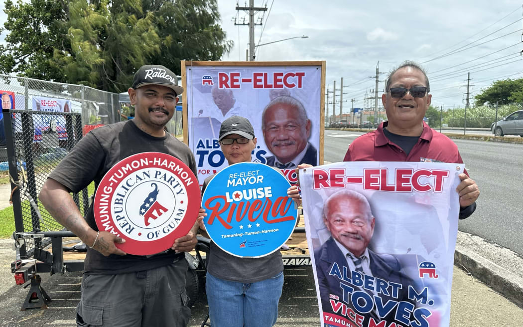 Candidate supporters line the main streets of Guam near polling booths.