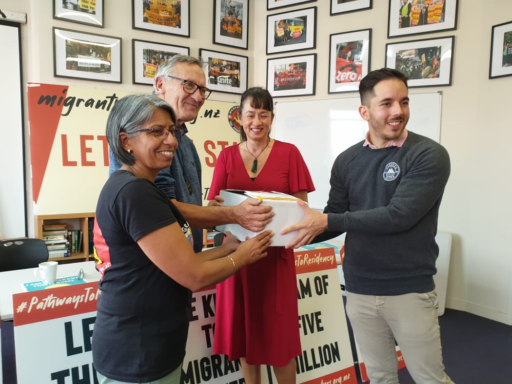 Anu Kaloti from the Migrant Workers Association and Mike Treen from the Unite Union present signatures to Labour MP Marja Lubeck and Green MP Ricardo Menéndez.