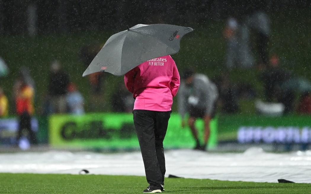 Match umpire watches the rain during the 3rd T20 cricket international between India and New Zealand at McLean Park in Napier, New Zealand.