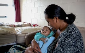 Nicole and her youngest child, who are paying $190 per night in emergency housing at a motel