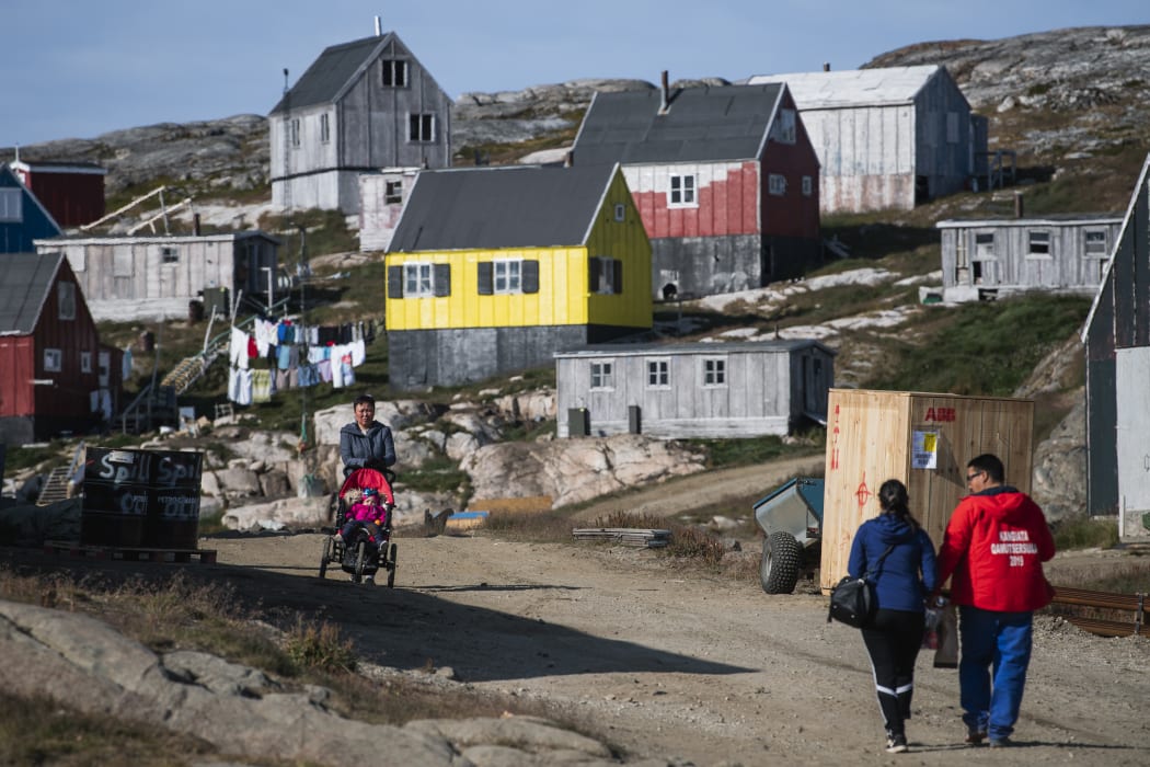People walking in Kulusuk, Greenland.
