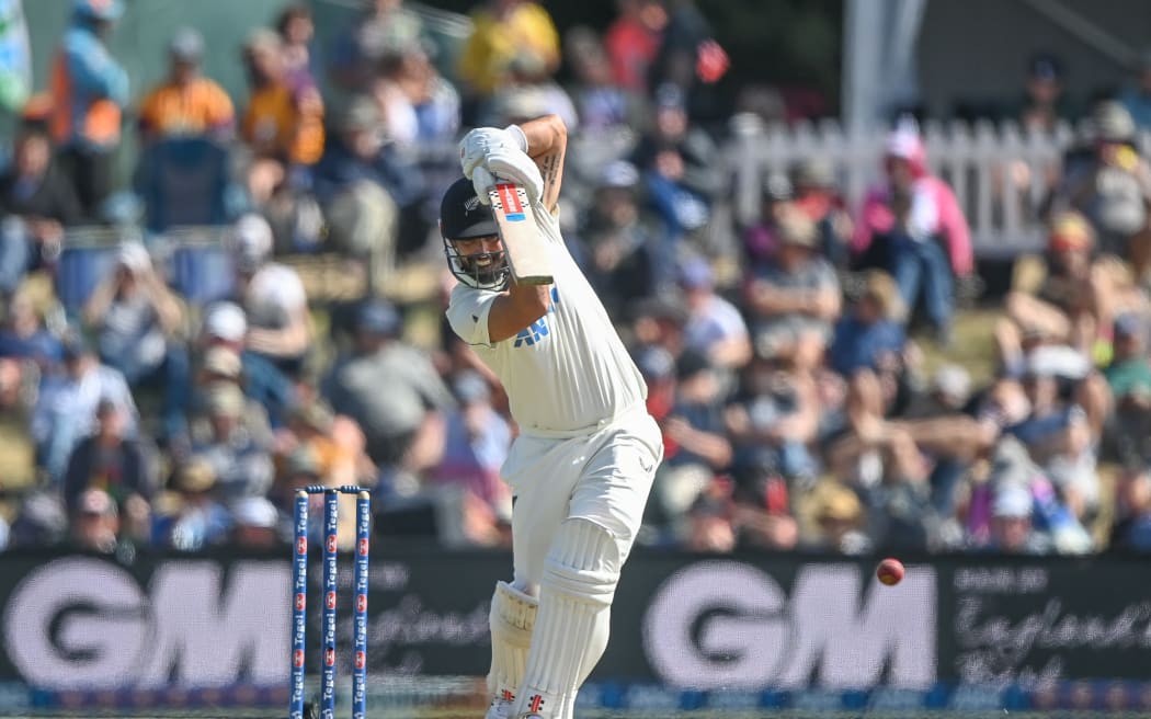 Daryl Mitchell drives on the third day of the first cricket test between New Zealand and England at Hagley Oval in Christchurch, Nov 30, 2024.
