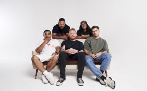 L.A.B. are sitting on a white couch