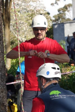 Judge Alvar Del Castillo checks the ropes for the speed climbing event.