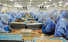 Workers at a food processing plant