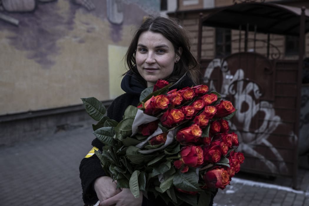 Women receive flowers on the International Women's Day as people flock to train station to flee the city after Russia announced a temporary ceasefire in Kyiv, Ukraine on March 08, 2022.