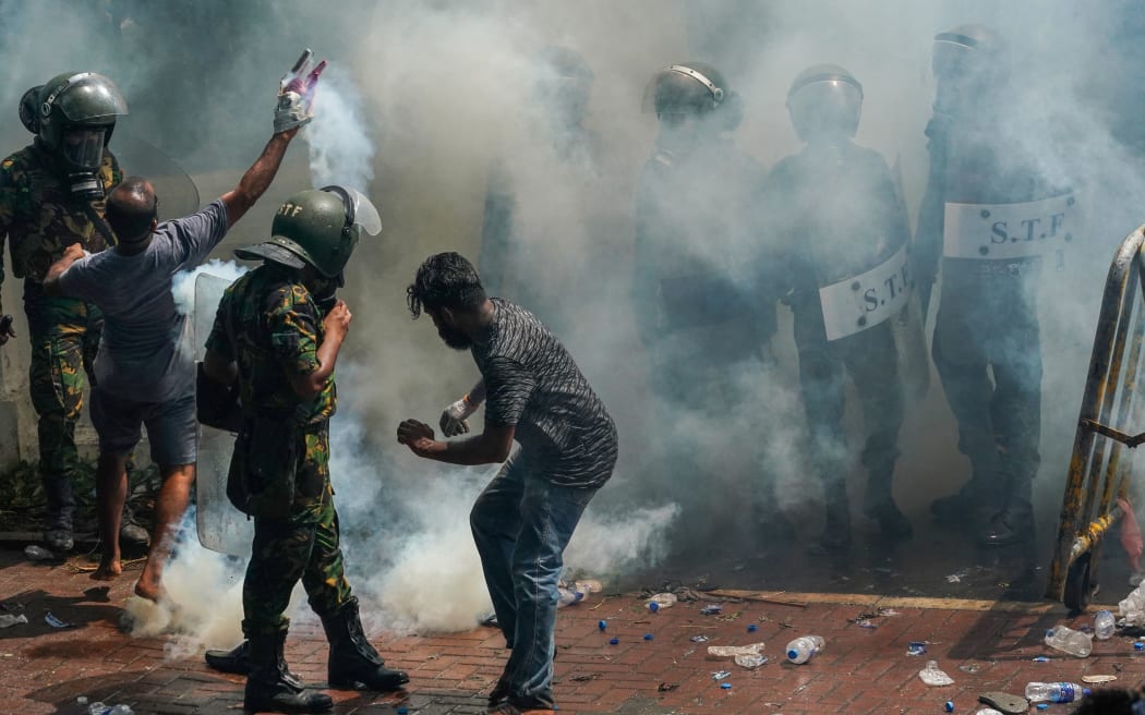 Anti-government protesters take over the Prime Minister’s office in Sri Lanka. Police use a large amount of tear gas and water cannons to disperse the crowd which failed to stop the crowds. July 13, 2022 Colombo, Sri Lanka (Photo by Thilina Kaluthotage/NurPhoto) (Photo by Thilina Kaluthotage / NurPhoto / NurPhoto via AFP)