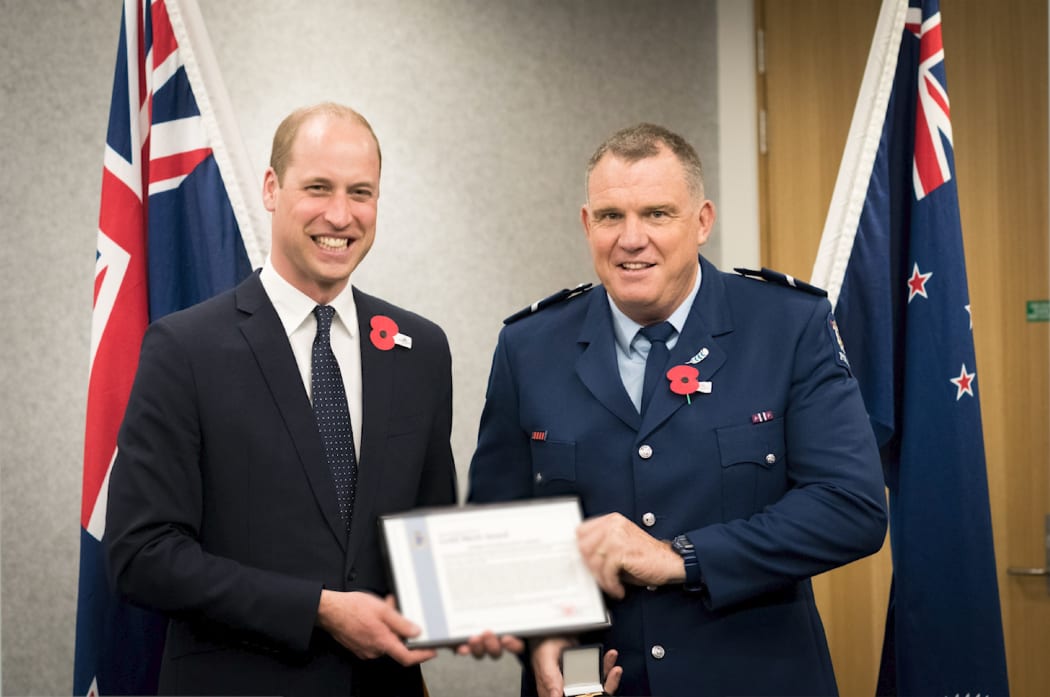 Senior Constable Jim Manning receiving an award from Prince William.